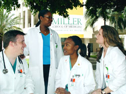 Third year FAU/UM students Russ Colombo ’08, Kareen Jones ’08, Colette Waite ’08, and Alison Fletcher ’08 discuss their rotations while enjoying a sunny day in the Schoninger Research Quadrangle at the University of Miami Miller School of Medicine.