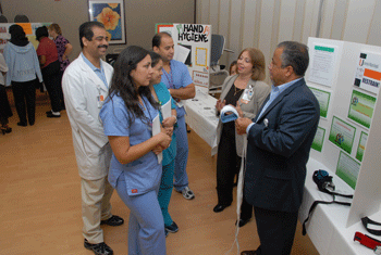 Tony Santa, associate vice president of the Department of Behavioral Health Services, and Hilda Rodriguez, clinical manager, demonstrate safe use of restraints to a group of clinical staff at the 2009 Safety Fair.