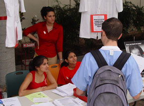Medical students Megha Garg, Natasha Chida, and Natasha Parekh speak to classmate William Dresen on World AIDS Day.