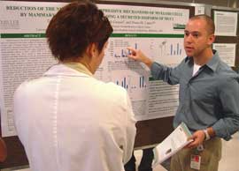 Dan Ilkovitch (right), a graduate student in the immunology laboratory of Dr. Diana Lopez at UM/Sylvester, explains his research to Dijana Gugic, M.D., a postdoctoral associate in pathology, at the 2007 Zubrod Memorial Lecture and Cancer Research Poster Competition. Ilkovitch earned second prize.