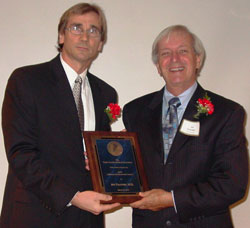 Dade County Medical Association President Stephan Baker, M.D., (left) presents UM's Arthur Fournier, M.D., with the Association's Lifetime Achievement Award at a Doctors' Day event. UM's Barth Green, M.D., F.A.C.S., also received a Lifetime Achievement Award Friday night, and Walter Lambert, M.D., was honored with the Physicians Recognition Award.
