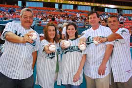 UM employees Juan Rosado, Dania Gamboa, Nicole Berman, Joe Natoli and Dean Pascal Goldschmidt, M.D., (left to right) threw out the first pitches at Saturday's Marlins game