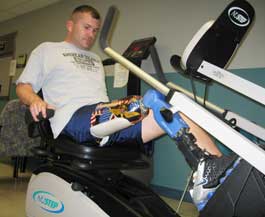 Sergeant First Class Michael McNaughton, injured in 2003 while serving with the Army National Guard in Iraq, demonstrates new equipment at the grand opening of the Functional Outcomes Research Evaluation Center at the Miami Veterans Affairs Medical Center.